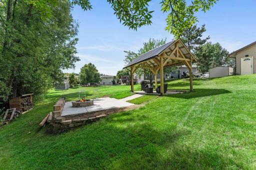 The backyard includes a gorgeous pergola and firepit, perfect for spending time outside during the Summer.