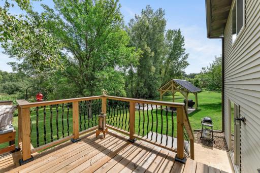 The deck overlooks the gorgeous backyard.