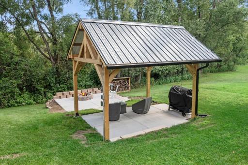 The backyard includes a gorgeous pergola and firepit, perfect for spending time outside during the Summer.