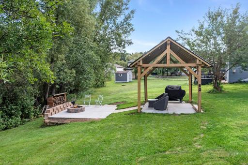 The backyard includes a gorgeous pergola and firepit, perfect for spending time outside during the Summer.