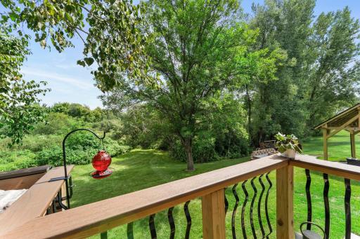 The deck overlooks the gorgeous backyard.