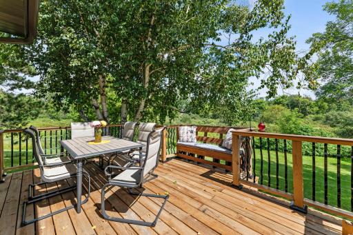 The deck overlooks the gorgeous backyard.