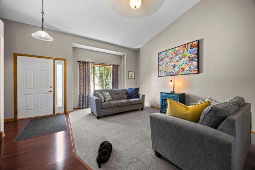 The living room features soaring vaulted ceilings.