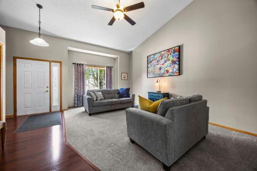 The living room features soaring vaulted ceilings.