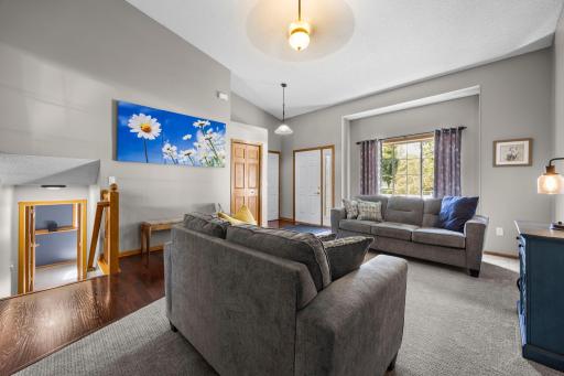The living room features soaring vaulted ceilings.