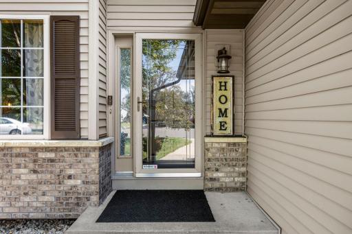 The exterior features vinyl siding and brick/stone accents.