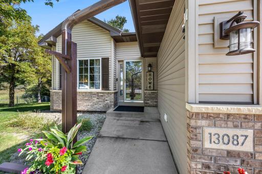 The exterior features vinyl siding and brick/stone accents.