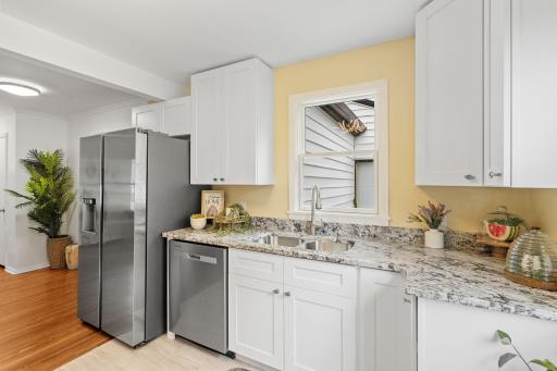 Additional kitchen upgrades include a brand-new refrigerator, dishwasher, and sink, all set beneath a window with a pleasant view.