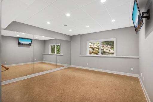 Walkout level exercise roomwith a cork floor