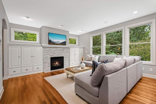 Family room with a gas fireplace flanked by built-ins