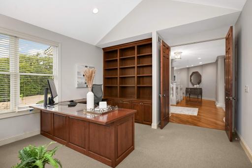 Main floor office has custom built-in bookcases and desk