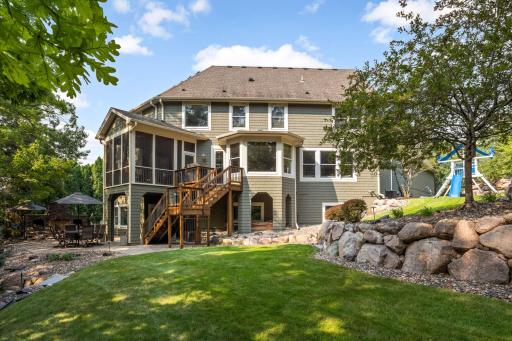 Lush landscaped backyard with two entertaining/play areas