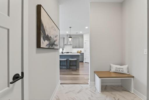 Spacious back entry off garage with built-in bench.
