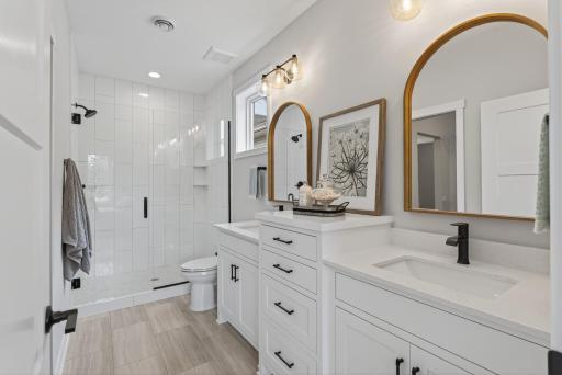 Private Primary Bath with custom vanity and fully tiled shower.