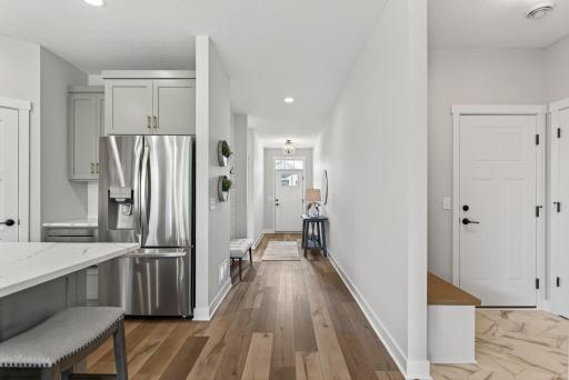 Front entry is inviting with an ideal spot for an entry bench, highlighted with shiplap and convenient hooks.