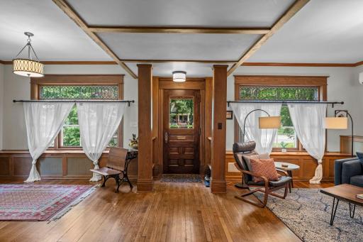 As you enter, you'll find original woodwork, coffered ceilings, leaded glass windows, and hardwood floors throughout.