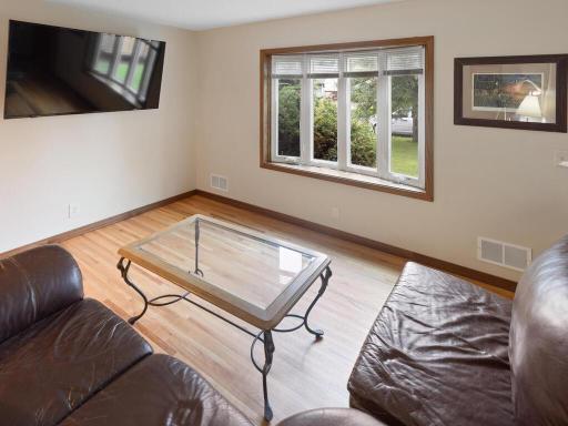 Spacious living room with bay window, beautiful hardwood floors
