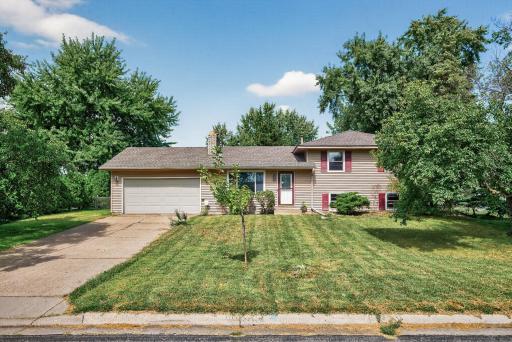 10616 Arrowhead St NW - Classic curb appeal with an attached garage and a spacious front yard.