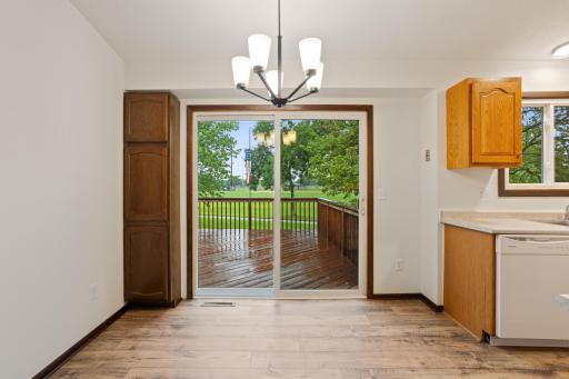 View of deck off dining/kitchen area. Back of home backs up to school and large sports field. No neighbors behind! Door to garage is to the left of this photo.