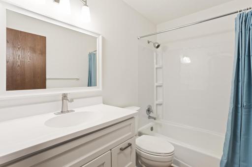 Bathroom has had a complete makeover. New tub surround, vanity, sink and faucet. Flooring is new as well.