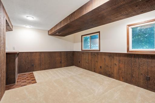 Lower level family room with small bar. New carpet.