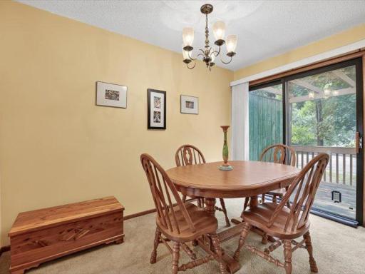 Light-filled dining space with sliding glass doors leading directly to the deck.
