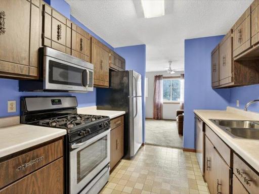 Kitchen features stainless steel gas range and built-in microwave, combining classic cabinetry with modern updates.