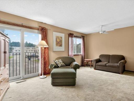 Bonus sitting nook in the living room with large window and ceiling fan, providing additional relaxation space.