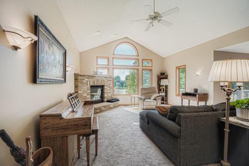 Enjoy the vaulted ceiling in the living room with a prime view of the open land behind the home through the bank of south facing windows
