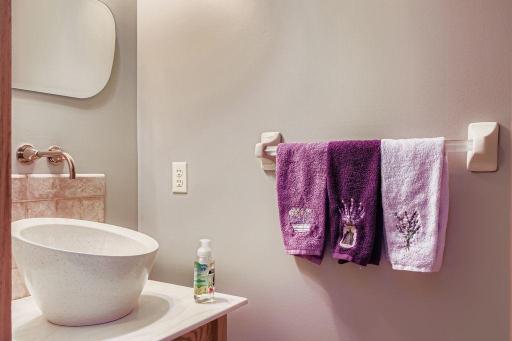 Main floor powder room is conveniently located just past the kitchen