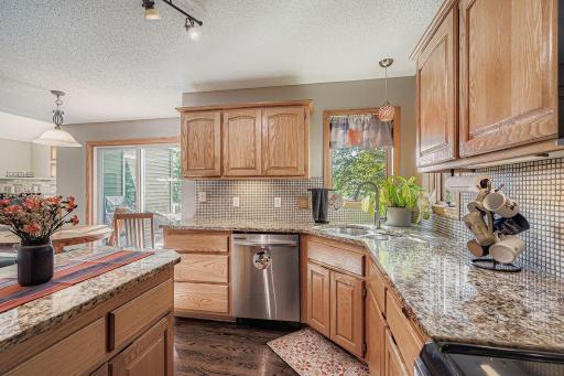 The granite countertops and tile backsplash add to the ambiance of the space