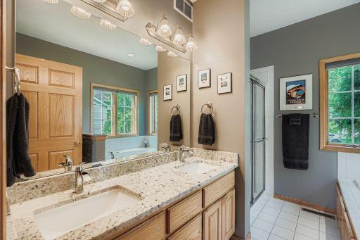 The owner's bath boasts dual sinks, granite counter and a separate shower