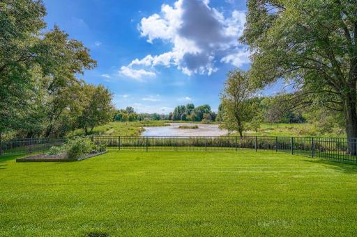 the fenced back yard is a wonderful setting for playing and gardening!