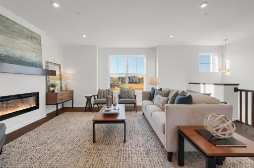 The Afton living space offers balance, a space to unwind with a sleek electric fireplace, where warmth, and a touch of elegance create the perfect escape to relax and recharge after a long day