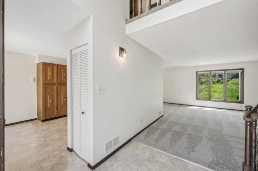 Coat closet and divide between the main level living room and kitchen