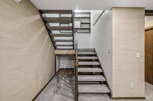 Stairs to the lower level with convenient storage below
