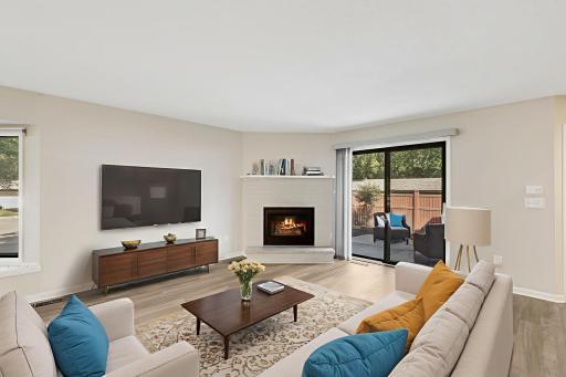 Main Floor Family Room with gas fireplace and patio door lead to the private patio