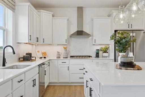 (Photo is of model home, finishes will vary) The kitchen is equally stylish and practical with sleek cabinetry, high-end finishes and all-new stainless steel appliances.