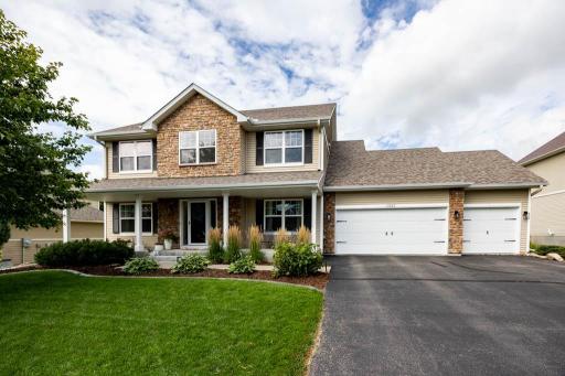 front of house has porch and 3 car garage