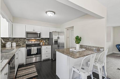 Kitchen features sleek cabinetry and granite countertops.