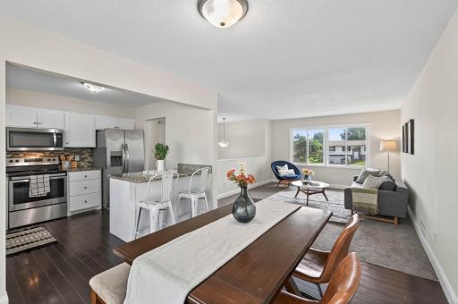 Modern kitchen with stainless steel appliances and island seating.