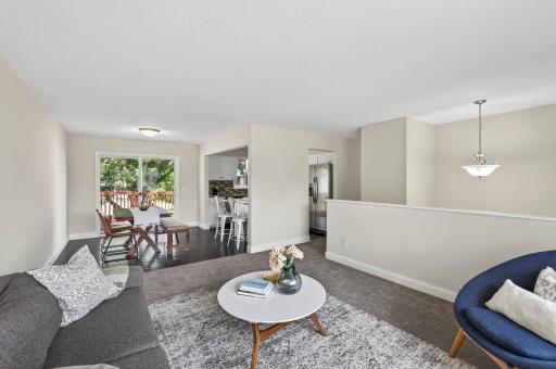 Open flow from living room into dining and kitchen areas.