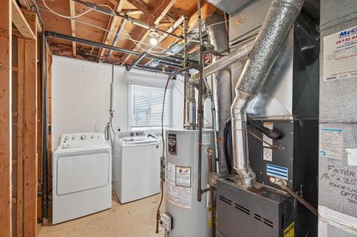 Laundry room with washer/dryer and storage.