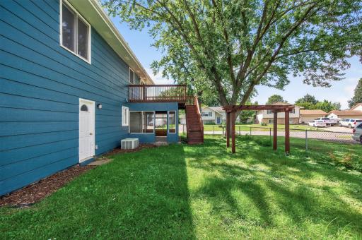 Large fenced backyard with mature landscaping.