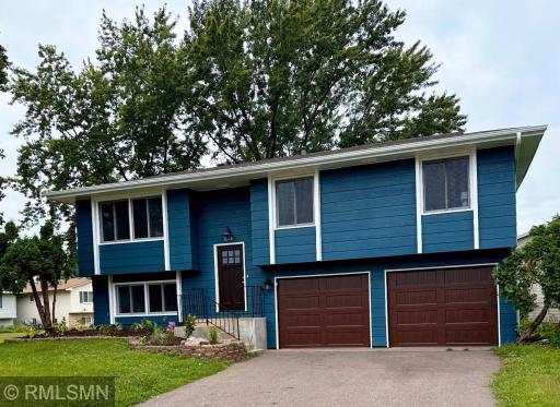 Charming curb appeal with new garage doors and welcoming front entrance.