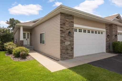 Welcome to this meticulously maintained 2018 built main level living end unit townhome. This home has barely been lived in the past 3 years and is move-in ready for you! The garage door is 8' tall and the garage measures 22'x21'.