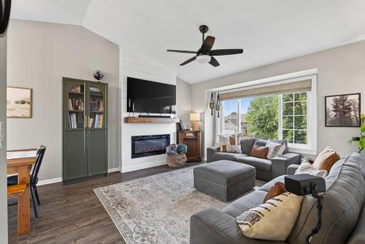 Light & bright vaulted living room with box bay window plus an electric fireplace