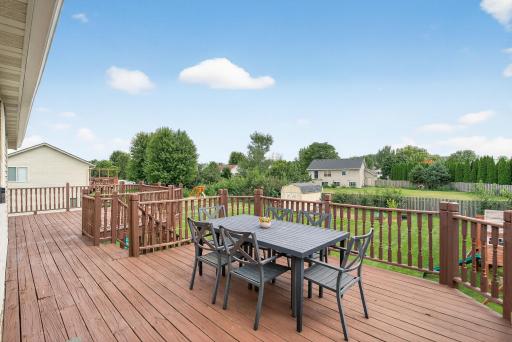 Freshly stained deck expands the entire back of the home