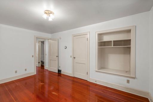 Built-ins galore! Beautiful paneled doors and trim accent natural wood flooring.