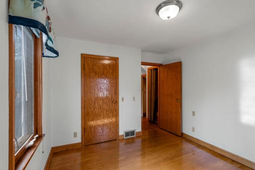 Main level bedroom with hardwood floors and double windows. 19 Main level bedroom with hardwood floors and double windows.
